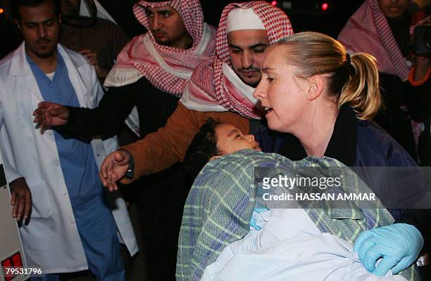 Nurse carries Ahmad Al Zahrani on arrival to Riyadh air base in the Saudi capital Riyadh, early on February 6, 2008 after being repatriated from...