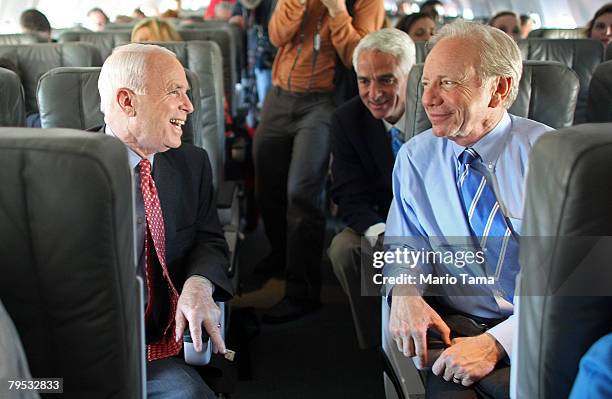 Sen. Joe Lieberman , Florida Gov. Charlie Crist and Republican presidential candidate and Senator John McCain sit on the campaign plane before a...