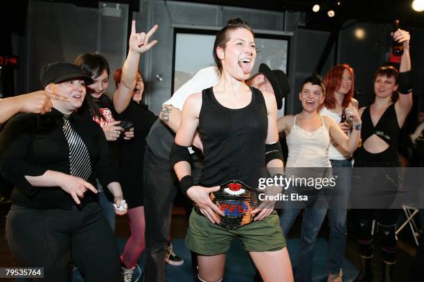 Boozy Suzy and her fellow fighters celebrate as commissioner Stacey Case puts on the PFL championship belt on her at the Petit Campus on May 5,1007...