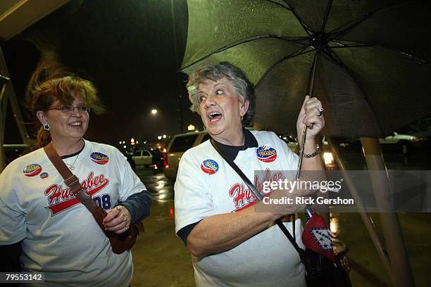 Melanie Ross and Carolyn Carver brave the bad weather to make it to a Super Tuesday watch party for Republican presidential hopeful Mike Huckabee...