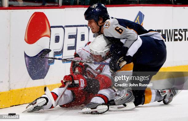 Shea Weber of the Nashville Predators takes down Eric Staal of the Carolina Hurricanes on February 5, 2008 at the Sommet Center in Nashville,...