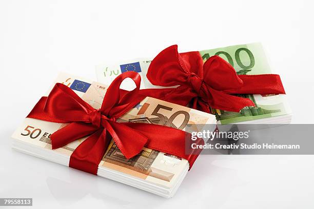 bunches of banknotes tied as gift - valuta stock pictures, royalty-free photos & images