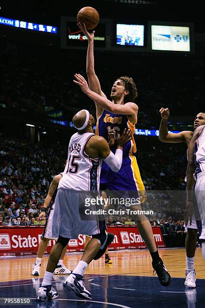 Pau Gasol of the Los Angeles Lakers shoots over Vince Carter of the New Jersey Nets at the Izod Center on February 5, 2008 in East Rutherford, New...