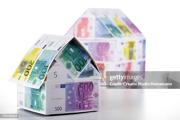 two houses of euro notes - valuta stock pictures, royalty-free photos & images