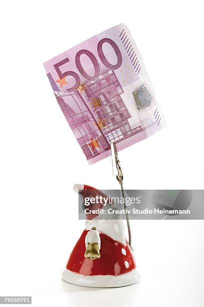 santa claus figurine holding euro note - five hundred euro banknote stock pictures, royalty-free photos & images