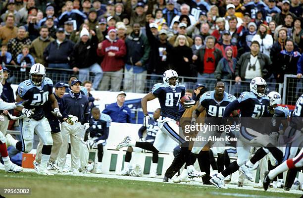 Tennessee Titans wide receiver Kevin Dyson takes a kickoff return 75 yards for a touchdown during the AFC Wildcard Playoff, a 22-16 victory over the...