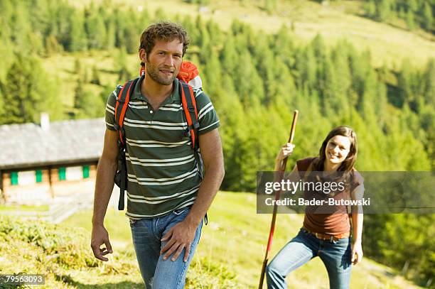 young couple in mountains - alm hütte stock-fotos und bilder