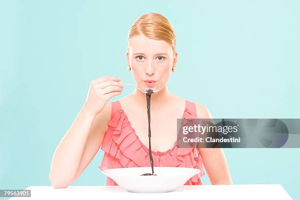 woman eating noodles, portrait - plate eating table imagens e fotografias de stock