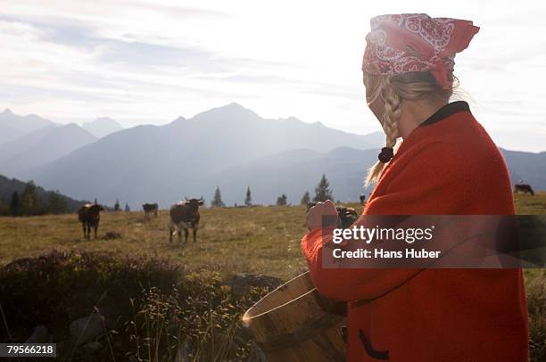 woman holding butter tub, cow in background - butter churn stock pictures, royalty-free photos & images