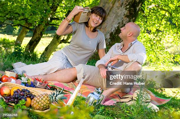 couple having picnic under tree - wellness kindness love stock pictures, royalty-free photos & images