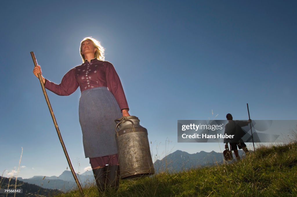 Couple in mountains holding crook