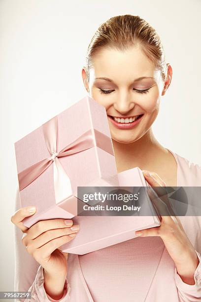 young woman opening gift box, smiling, close-up - cut out happy ストックフォトと画像