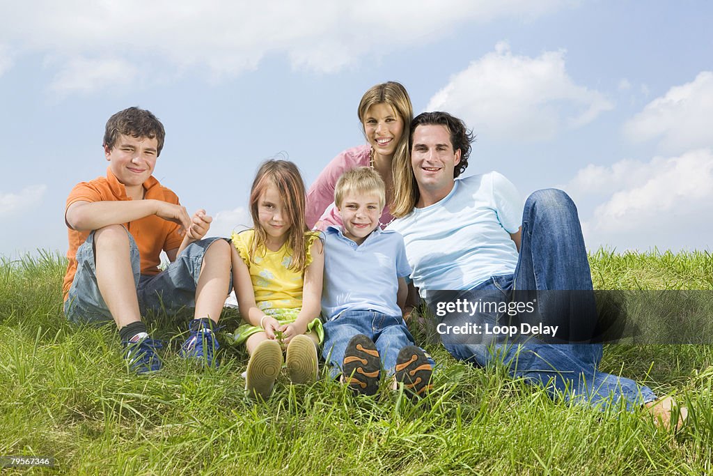 Family sitting in meadow