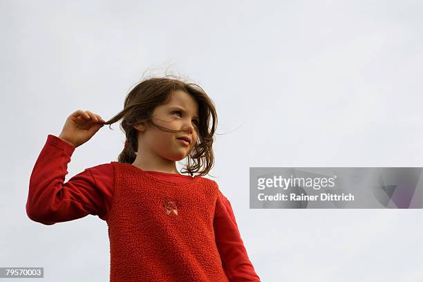 girl (7-9), hand in hair - wispy stock pictures, royalty-free photos & images