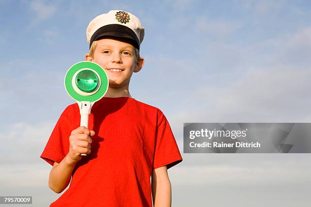 boy (10-13) wearing police cap - berretto da uniforme foto e immagini stock