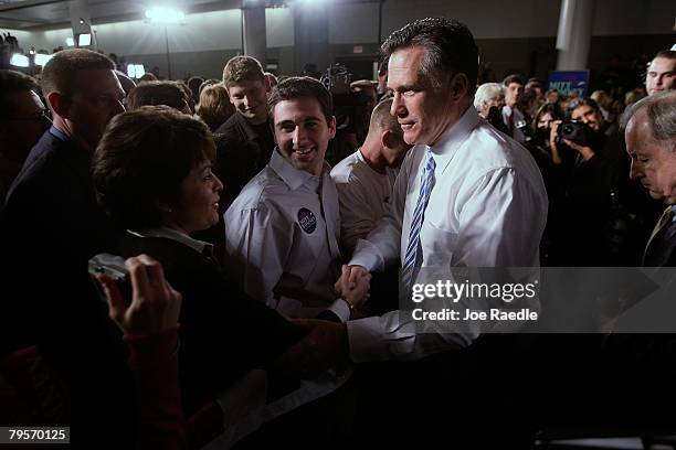 Republican presidential candidate and former Massachusetts governor Mitt Romney shakes hands with supporters during his Super Tuesday night party at...