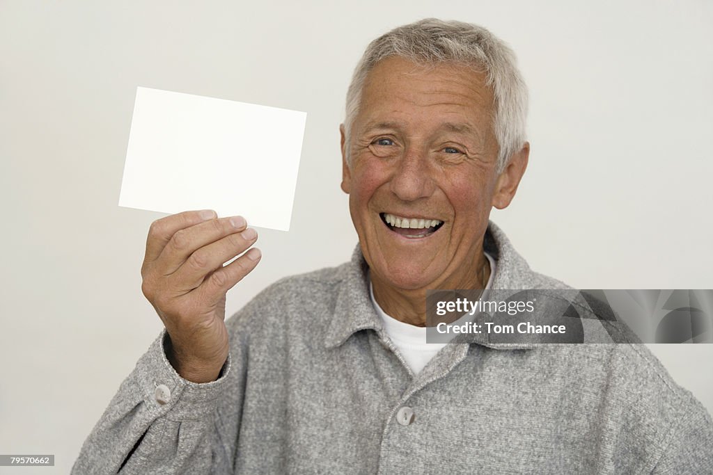 Senior man holding memo, close-up