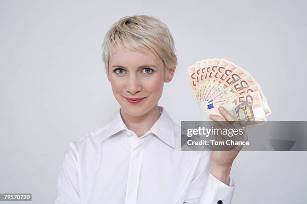 young woman holding money, portrait - arrogant stock-fotos und bilder