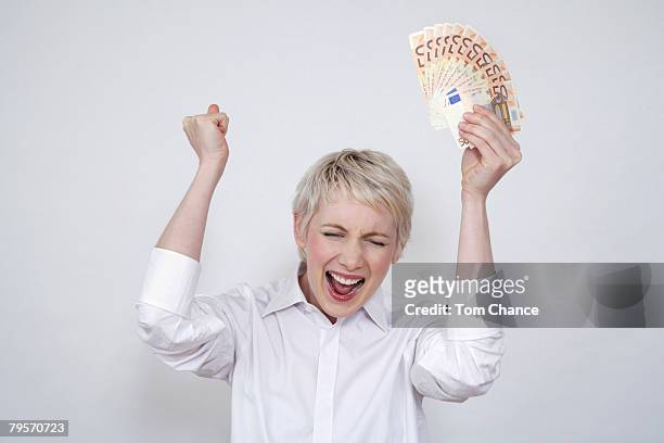 young woman holding money, portrait - euphoric female stock-fotos und bilder