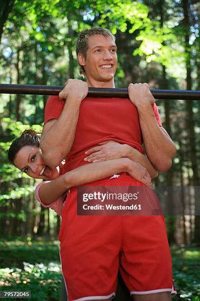 couple exercising on horizontal bar - dumb blonde stock pictures, royalty-free photos & images