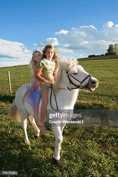 two girls on horse back - girl with legs open stock pictures, royalty-free photos & images