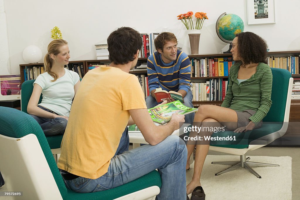 Four young people sitting in circle