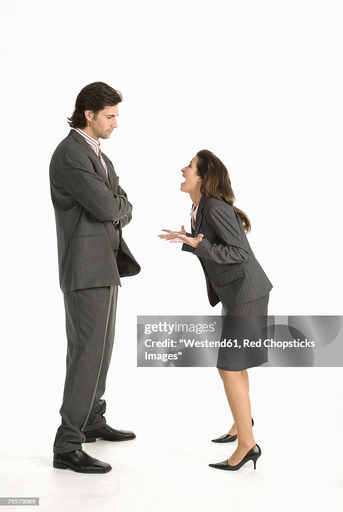 Business woman laughing at business man