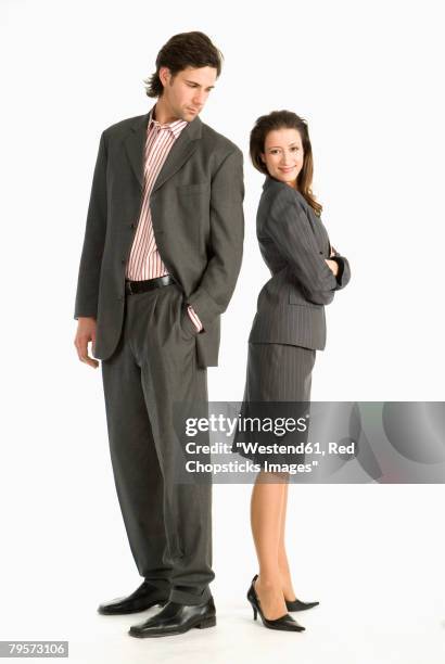 two businesspeople standing back to back - envious look stock pictures, royalty-free photos & images