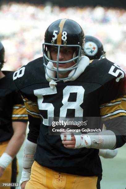 Linebacker Jack Lambert of the Pittsburgh Steelers looks on from the sideline during a game against the Denver Broncos at Three Rivers Stadium on...