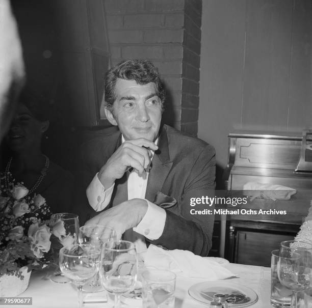 Actor and singer Dean Martin enjoys a night out at a club circa 1963 in Los Angeles, California.