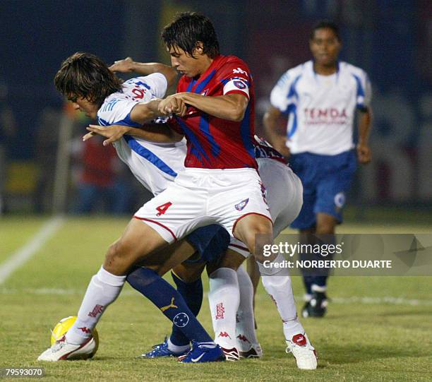 Marcelo Martins of Brazil's Cruceiro vies for the ball with Nelson Cabrera of Cerro Porte?o of Paraguay during their Copa Libertadores match at...