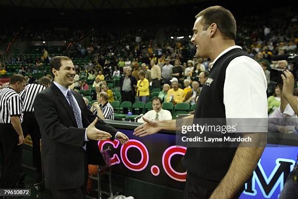 Pat Knight, head coach of the University of Texas Tech Red Raiders basketball team has a pregame handshake with Scott Drew, head coach of the...