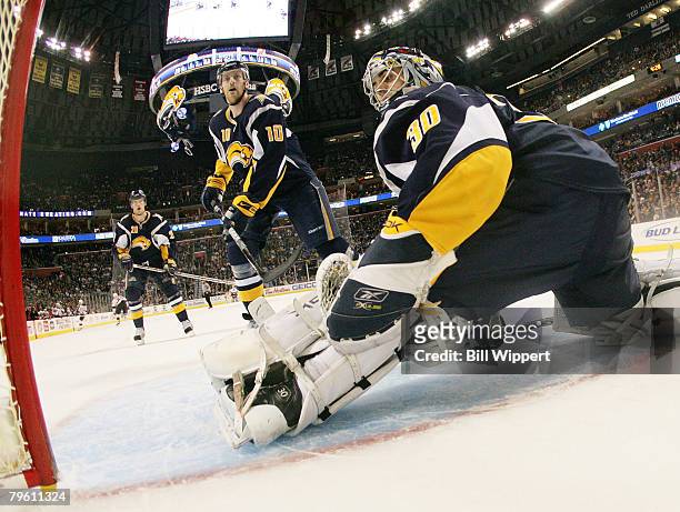 Ryan Milller and Henrik Tallinder of the Buffalo Sabres look for the puck against the New Jersey Devils on February 6, 2008 at HSBC Arena in Buffalo,...