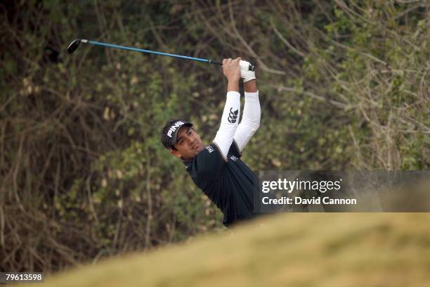 Shiv Kapur of India hits his second shot at the 18th hole during the first round of the Emaar-MGF Indian Masters at the Delhi Golf Club on February...