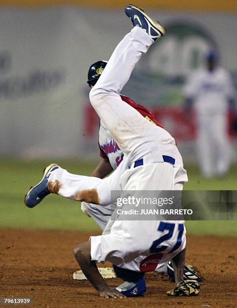 Anderson Hernandez of Tigres de Licey of Dominican Republic tags out in second base Tonny Pena of Aguilas del Cibao, also of Dominican Republic,...