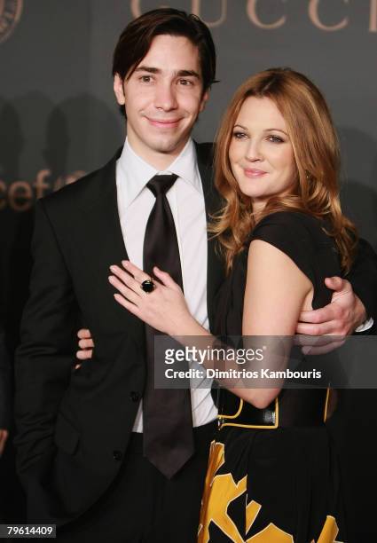 Actor Justin Long and actress Drew Barrymore arrive at the Madonna + Gucci Present A Night to Benefit Raising Malawi at the United Nations on...