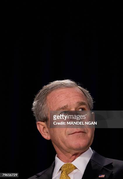 President George W. Bush looks at a speaker during the National Prayer Breakfast February 7, 2008 at the Washington Hilton Hotel in Washington, DC....