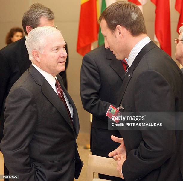 Defense Secretary Robert Gates talks with Canada's Defense Minister Peter Gordon MacKay at the start of an informal meeting of NATO defense ministers...
