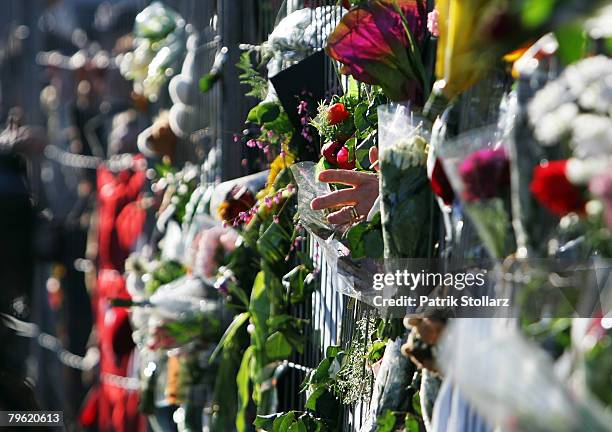 Flowers are seen at a fence near a burnt down house on February 7, 2008 in Ludwigshafen, Germany. On Sunday, February 3, the apartment building...