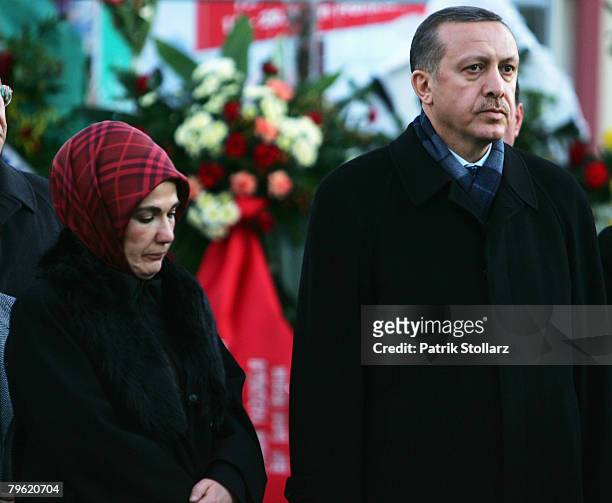 Turkish Prime Minister Recep Tayyip Erdogan and his wife Ermine look on during a visit at the house which burned down on February 7, 2008 in...