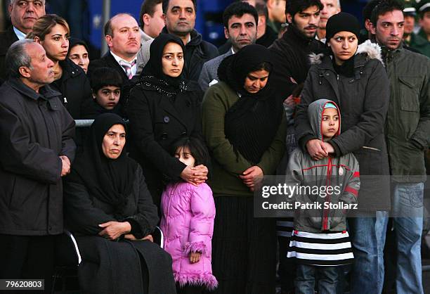 Family members of the victims listen to Turkish Prime Minister Recep Tayyip Erdogan and Rhineland-Palatinate's State Premier Kurt Beck during a visit...