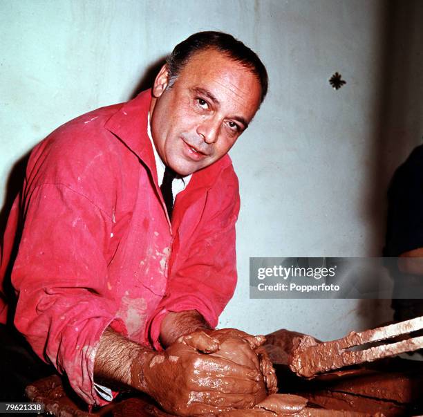 Picture of British actor Herbert Lom working on a potters wheel with some clay