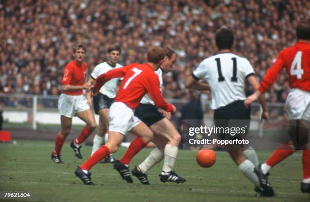 30th July 1966, 1966 World Cup Final at Wembley, England 4 v West Germany 2 after extra time, England's Alan Ball chases West Germany's Uwe Seeler as...