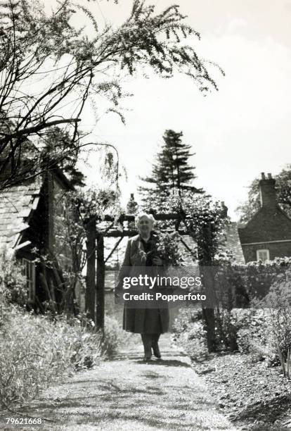 English writer and novelist Agatha Christie walks up a path in the grounds of her home, Winterbrook House near Wallingford, Oxfordshire in 1950....