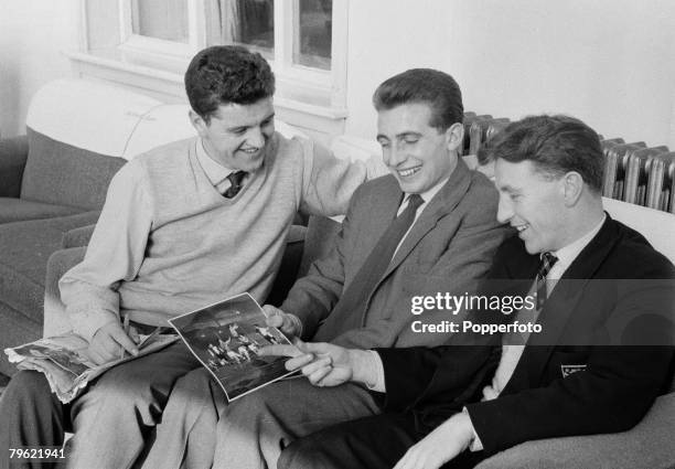 Sport, Football Manchester, England, Manchester United players Tommy Taylor, David Pegg & Roger Byrne look at a action photograph taken at a football...