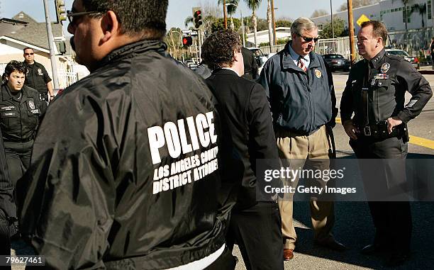 Assistant Police Chief Jim McDonnell speaks with District Attorney Steve Cooley during the investigation at a suspect's home on Welby Street east of...