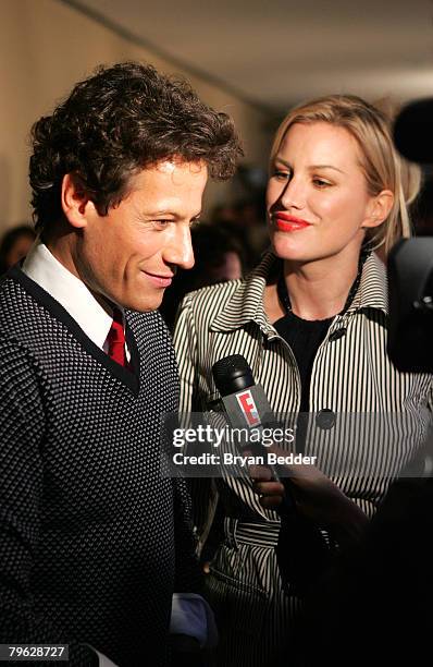 Ioan Gruffudd is interviewed as Alice Evans looks on backstage at the Tommy Hilfiger Fall 2008 fashion show during Mercedes-Benz Fashion Week Fall...