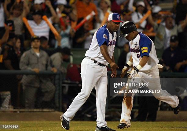 Rafael Furcal of Aguilas del Cibao Domoinican Republic celebrates with a coach after hitting a homerun during a Caribbean Series game against Tigres...