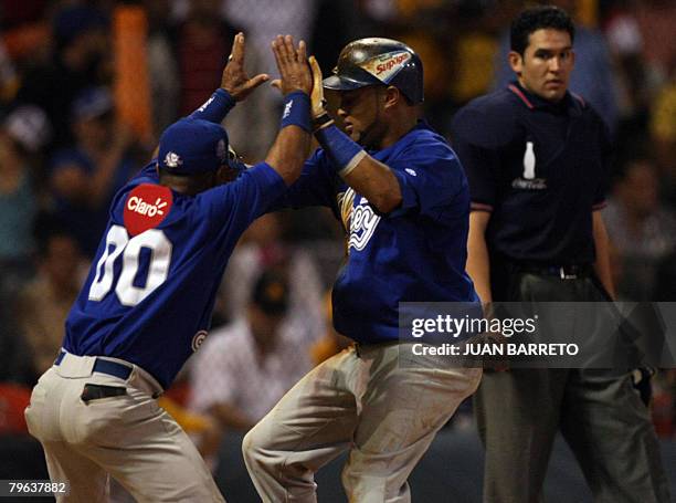 Mendy Lopez of Tigres del Licey of Dominican Republic celebrates with a batboy after hitting a homerun during a Caribbean Series game against Aguilas...