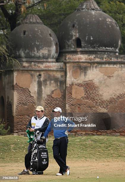 Graeme McDowell of Northern Ireland and caddie Ken Conboy during the second round of the Emaar-MGF Indian Masters at the Delhi Golf Club on February...